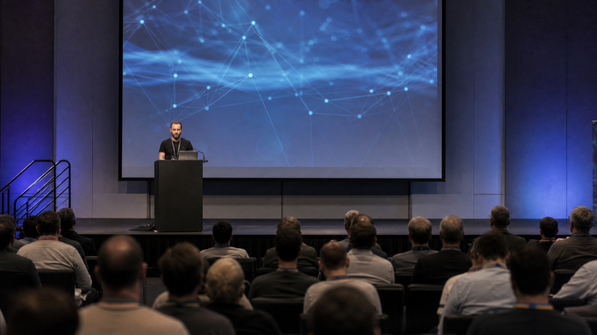 Cognition CEO Scott Wu speaking at a developer event. The company's Series D values Devin at $26 billion post-money, up from $10.2 billion eight months ago.