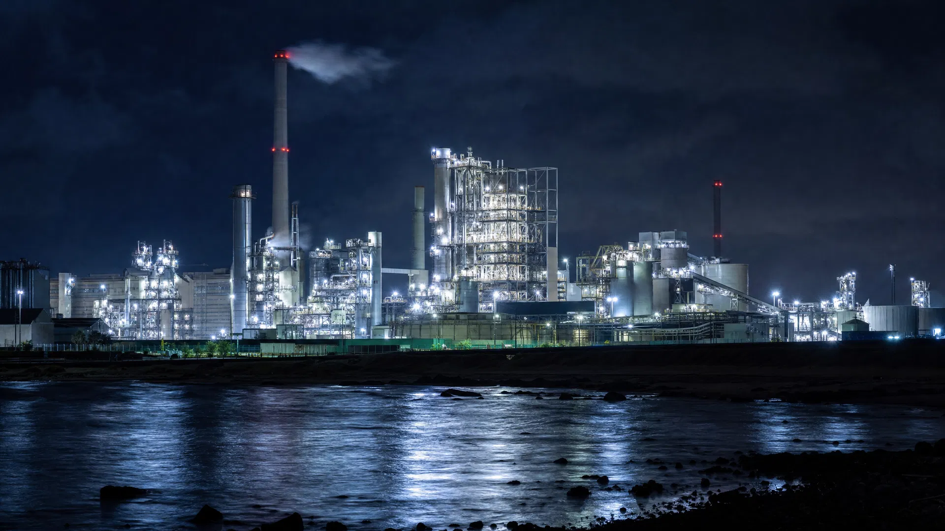 A coastal launch facility at night — the kind of infrastructure that SpaceX operates at Starbase in South Texas, where Flight 12 originated.